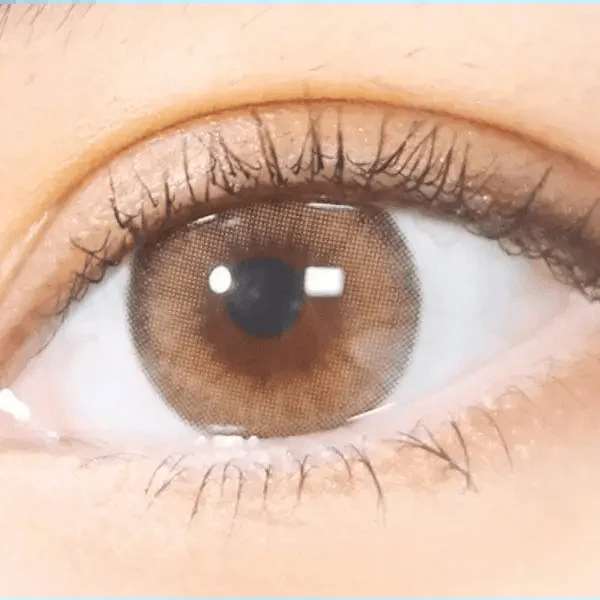Olens Nils Brown — single-eye close-up showing the contact lens appearance