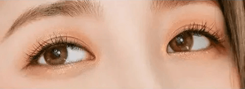 LensTown 247 With Me Olive (10p) — single-eye close-up showing the contact lens appearance