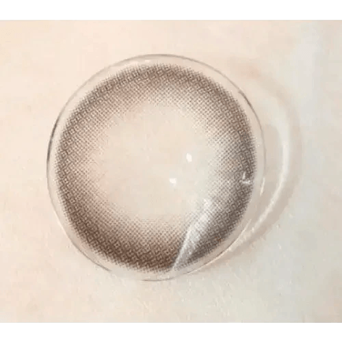 Olens And Black — contact lens held on a fingertip