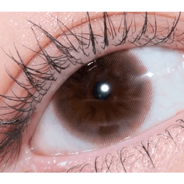 Olens Falling Brown — single-eye close-up showing the contact lens appearance