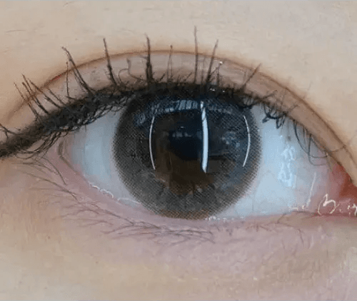 Olens ShineB Gray — single-eye close-up showing the contact lens appearance