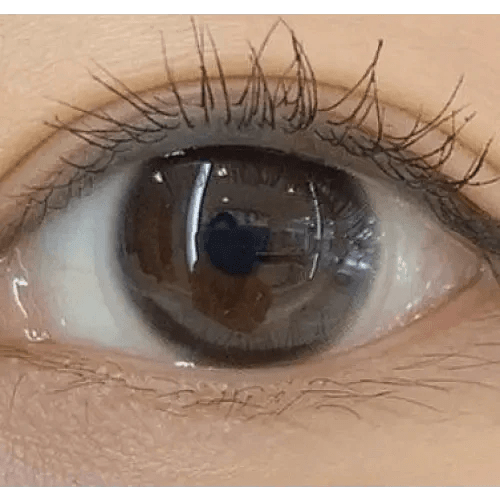 Olens Stay Black — single-eye close-up showing the contact lens appearance