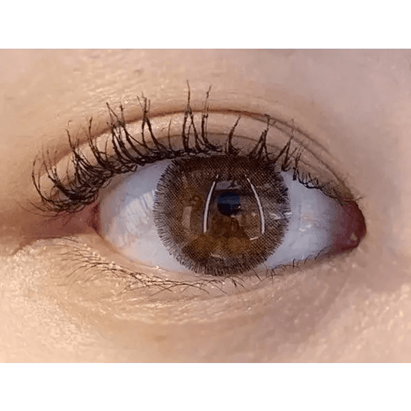 Olens Rich Brown — single-eye close-up showing the contact lens appearance
