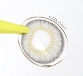 LensVery Blendy Gray — contact lens held with an applicator