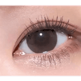 Olens Coming Choco — single-eye close-up showing the contact lens appearance