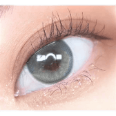 Olens Eyelighter Glowy Ash Gray — single-eye close-up showing the contact lens appearance