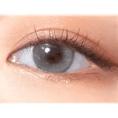 Olens Eyelighter Glowy Ash Gray — single-eye close-up showing the contact lens appearance