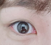 Olens Falling Choco — single-eye close-up showing the contact lens appearance