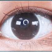 Olens It's Black — single-eye close-up showing the contact lens appearance