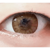 Olens Chandelier Brown — single-eye close-up showing the contact lens appearance