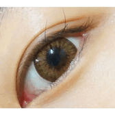 Olens Chandelier Brown — single-eye close-up showing the contact lens appearance