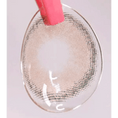 LensVery Funny Ann Ice Brown — contact lens held with tweezers