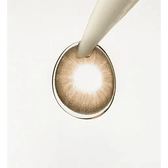 LensTown Hermera Brown — contact lens held with an applicator