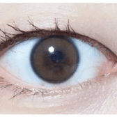 i-DOL Yurial Serum Brown — single-eye close-up showing the contact lens appearance
