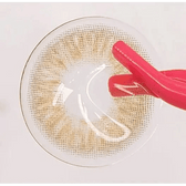 LensTown Kiralet Brown Toric — contact lens held with tweezers