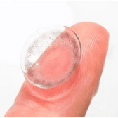 LensTown Lighly Lily Marry Gray (20p) — contact lens held on a fingertip
