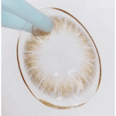 Olens Maybe Brown — contact lens held with tweezers