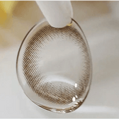 Olens It's Choco — contact lens held with tweezers