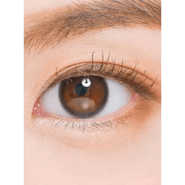 LensTown Nudy Coco Black — single-eye close-up showing the contact lens appearance