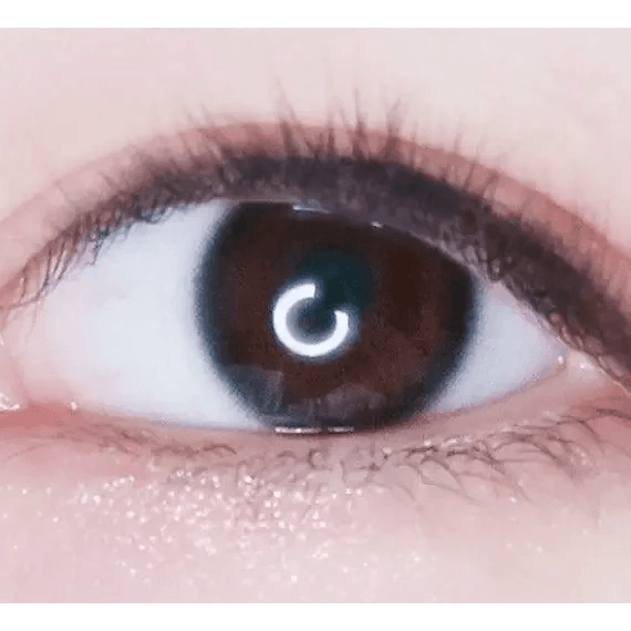 LensTown Nudy Coco Black — single-eye close-up showing the contact lens appearance