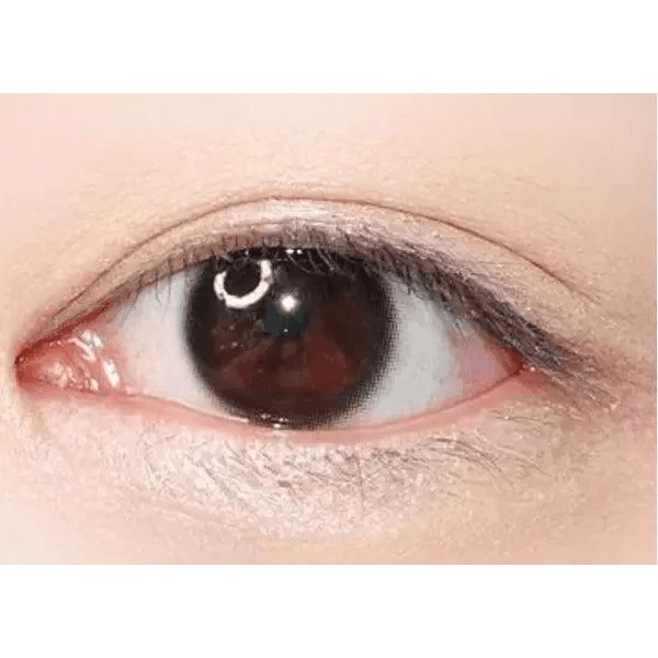 LensTown Nudy Coco Black — single-eye close-up showing the contact lens appearance