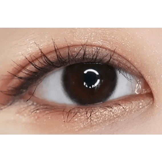 LensTown Nudy Coco Black Toric — single-eye close-up showing the contact lens appearance