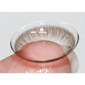 Olens SCL HI Brown — contact lens held on a fingertip