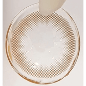 Olens Shining Pure Brown — contact lens held with tweezers