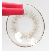 Olens Spanish Gray (20p) — contact lens held with tweezers