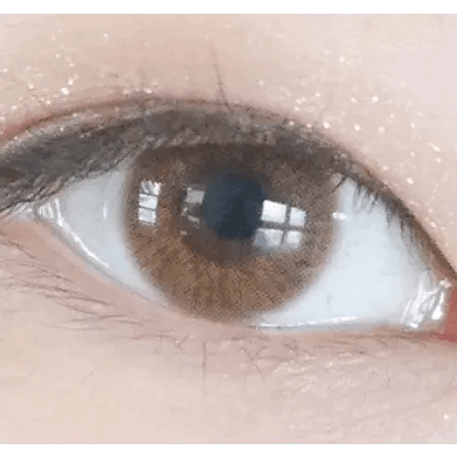 Olens TT 1 Brown — single-eye close-up showing the contact lens appearance